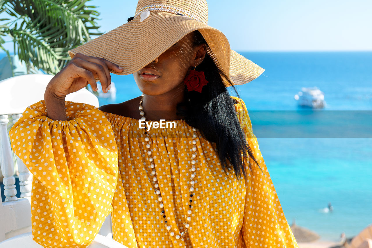 Portrait of beautiful african american model girl in stylish sun hat. fashion black 