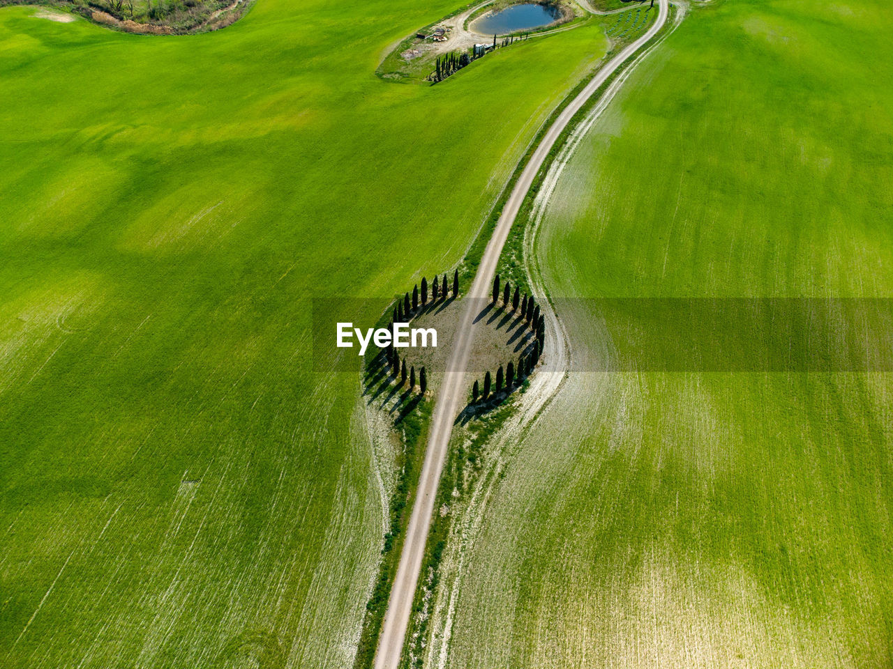 High angle view of road amidst green field