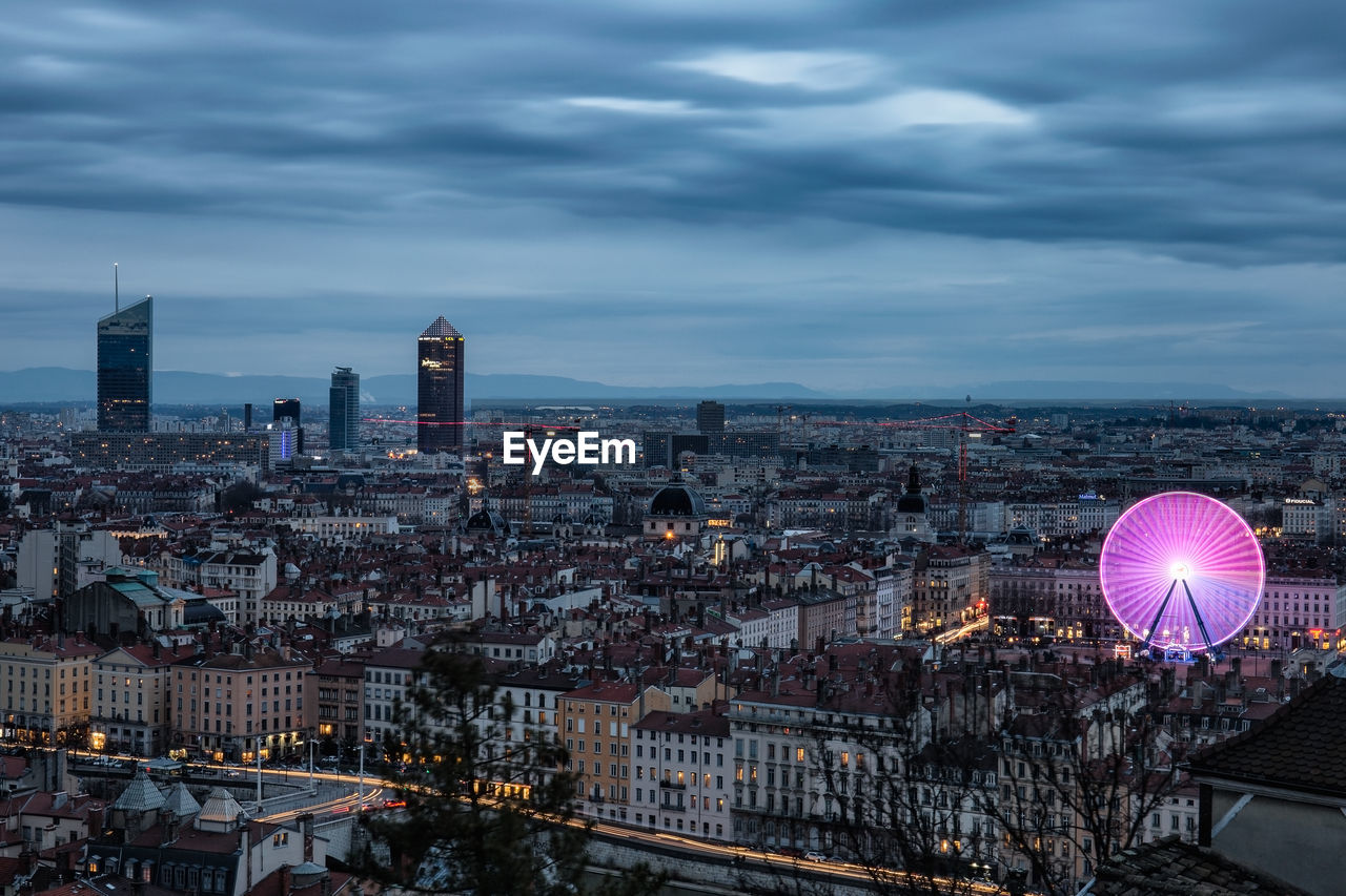 High angle view of cityscape against cloudy sky during sunset