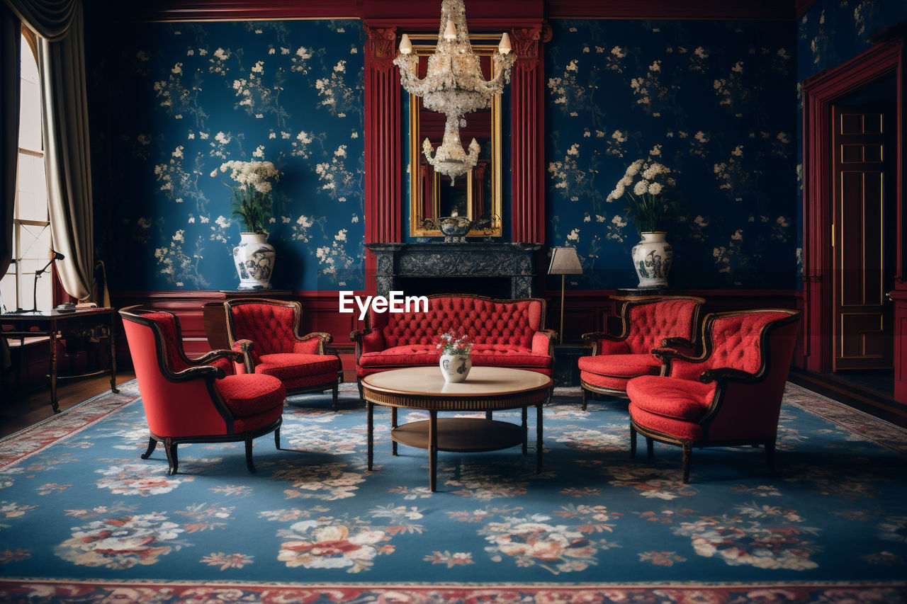 seat, chair, architecture, indoors, furniture, table, stage, building, red, wealth, no people, luxury, built structure, room, carpet, interior design, elegance, absence, history, lighting equipment, the past, flooring