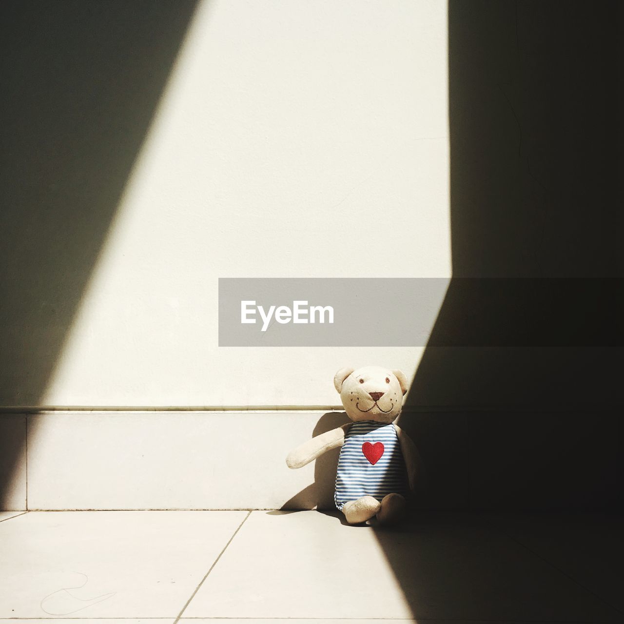 Cute teddy bear on floor at home