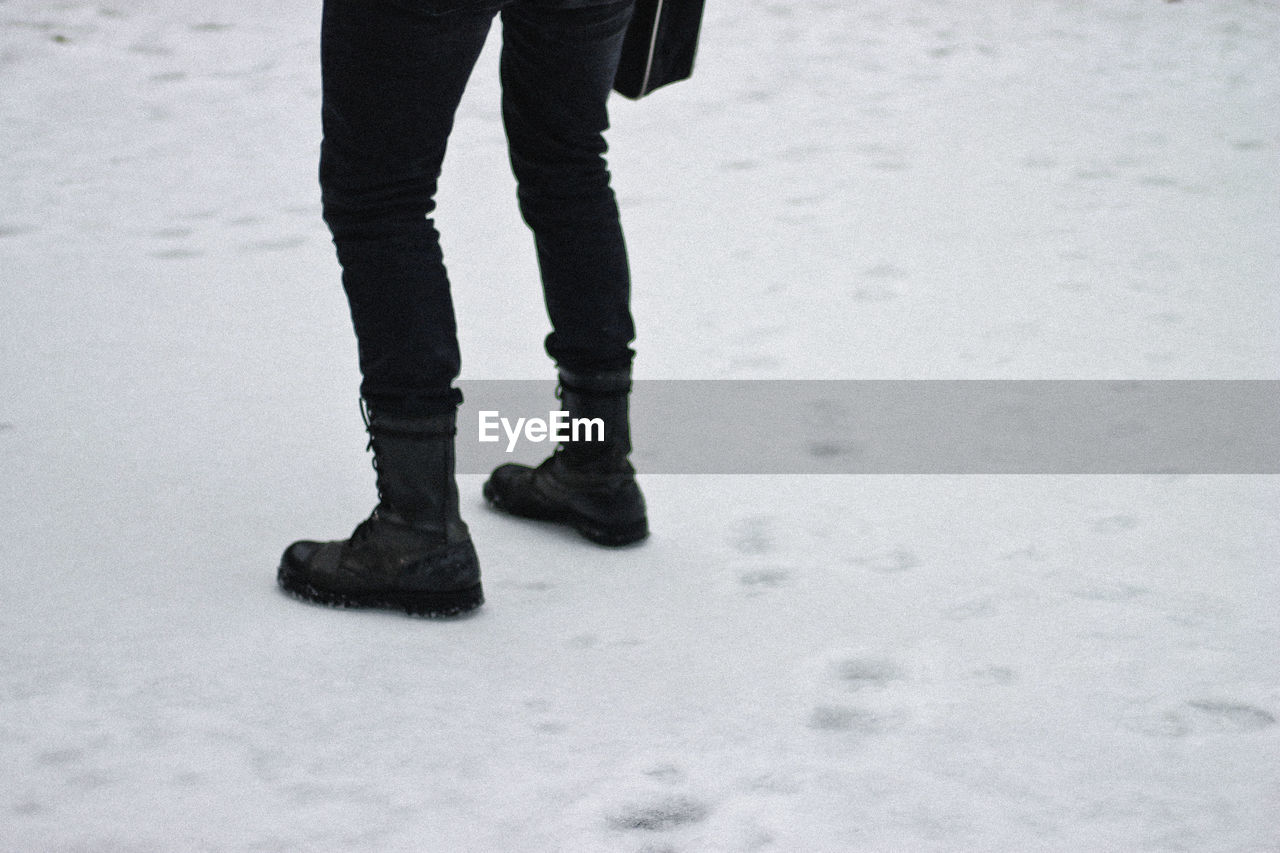 Low section of a person standing on snow