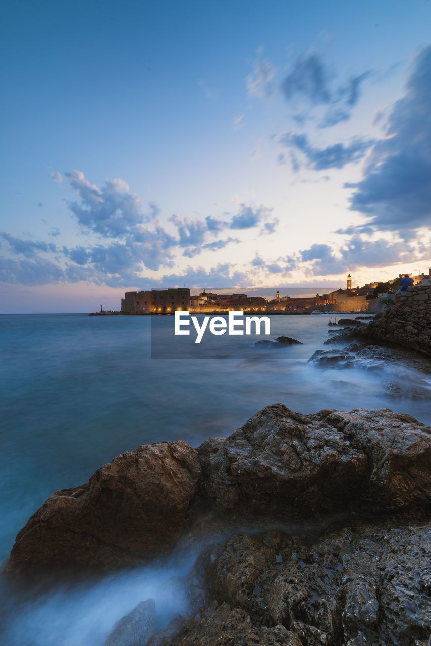 Scenic view of sea against cloudy sky