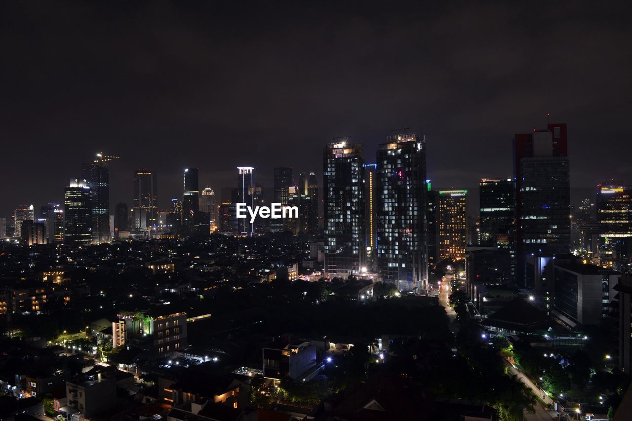 ILLUMINATED BUILDINGS IN CITY AT NIGHT