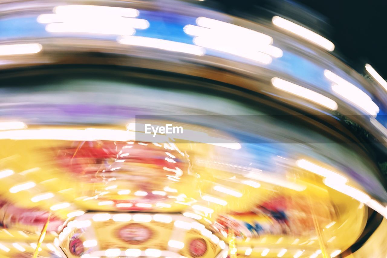 Light trails in amusement park at night