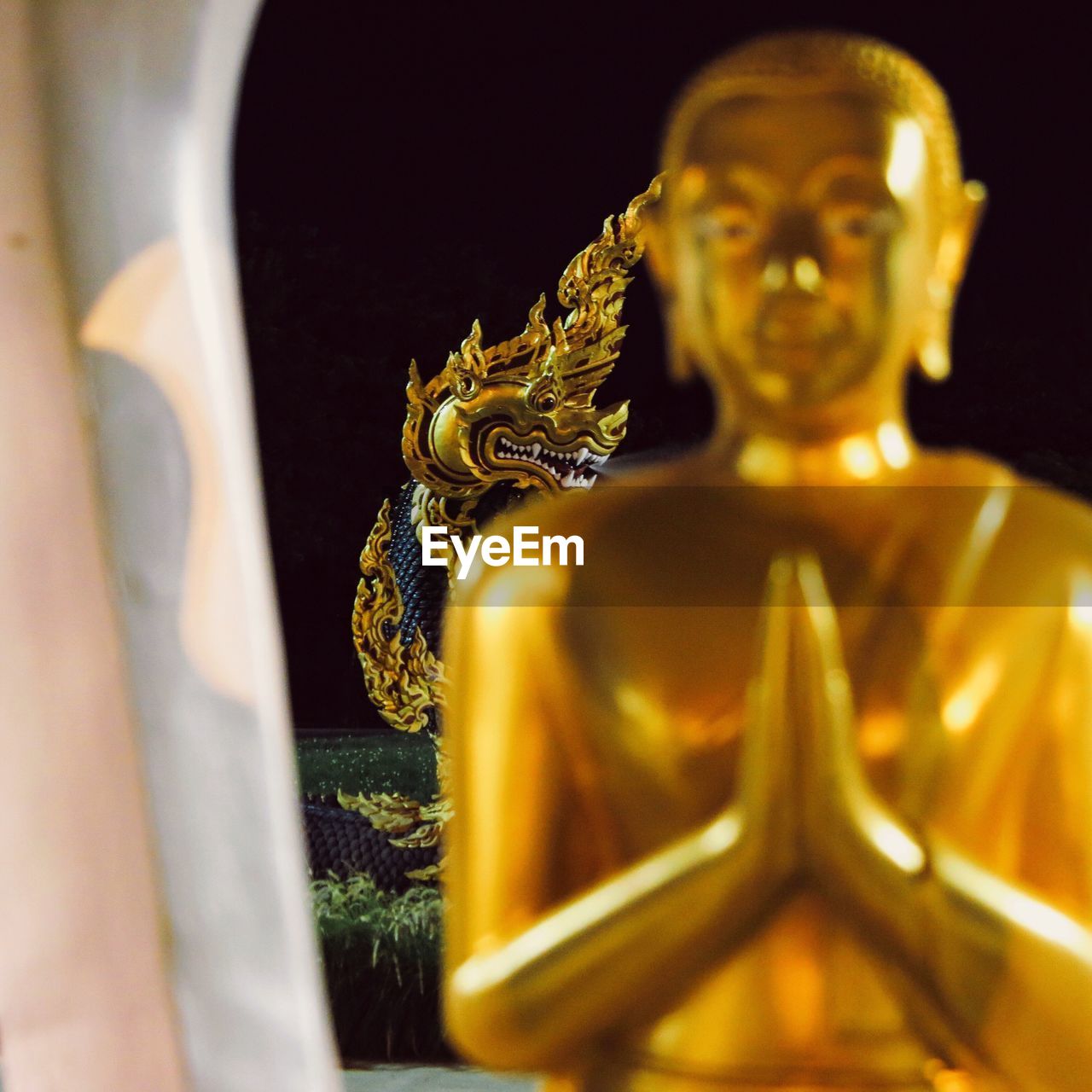 Close-up of gold statue against temple