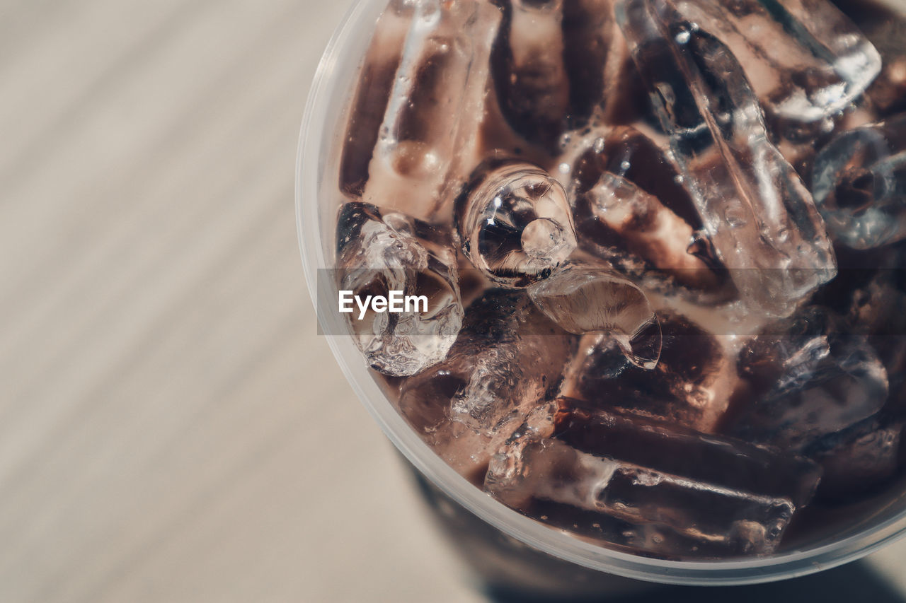 CLOSE-UP OF ICE CREAM ON TABLE