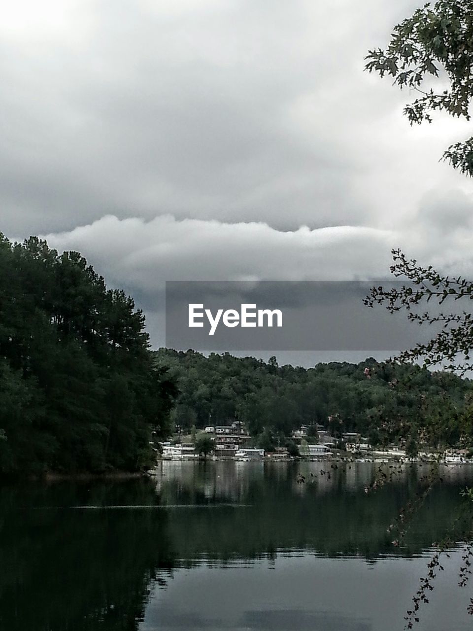 SCENIC VIEW OF LAKE AGAINST CLOUDY SKY