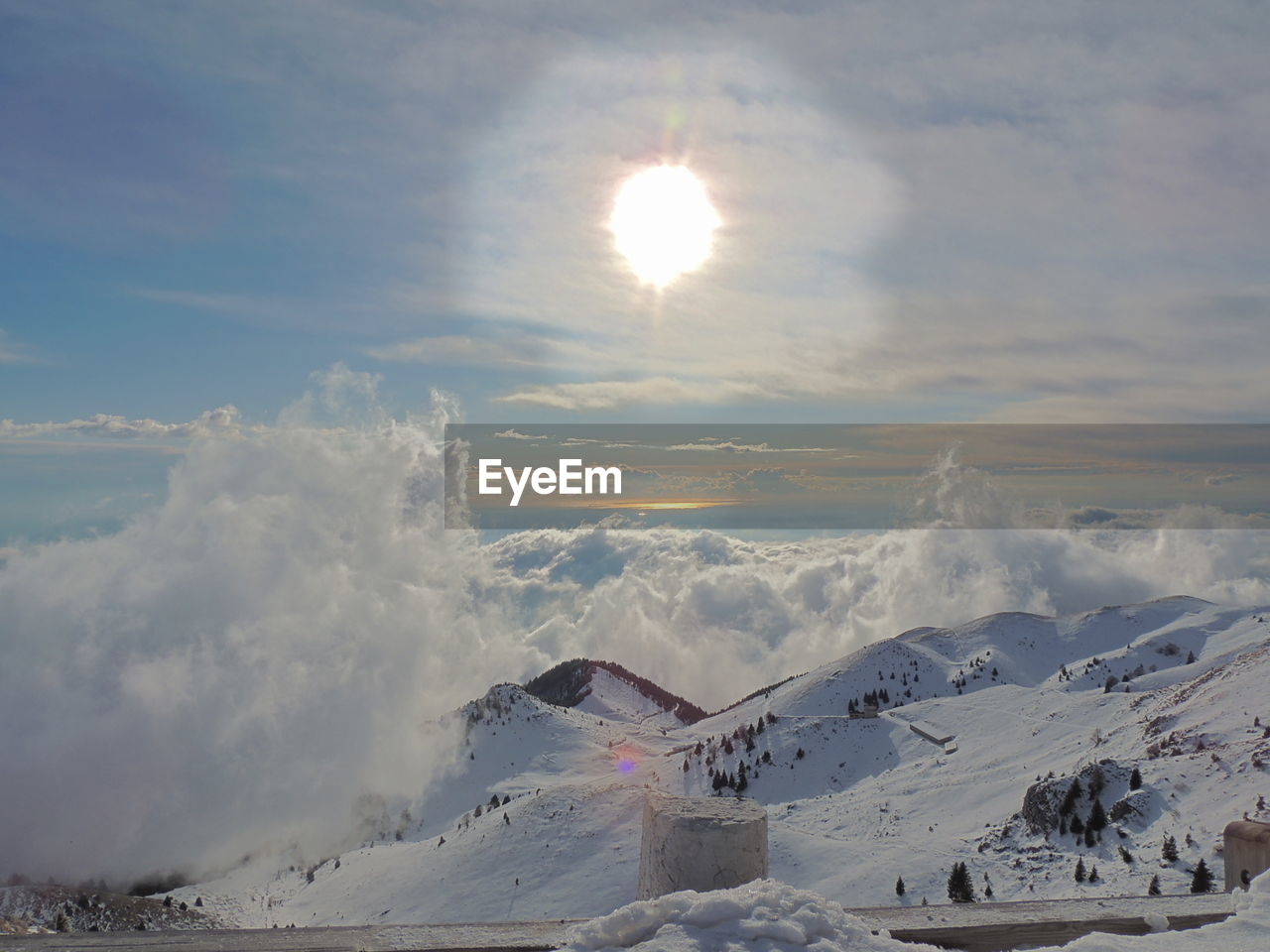 Scenic view of snow covered mountains against sky during sunset