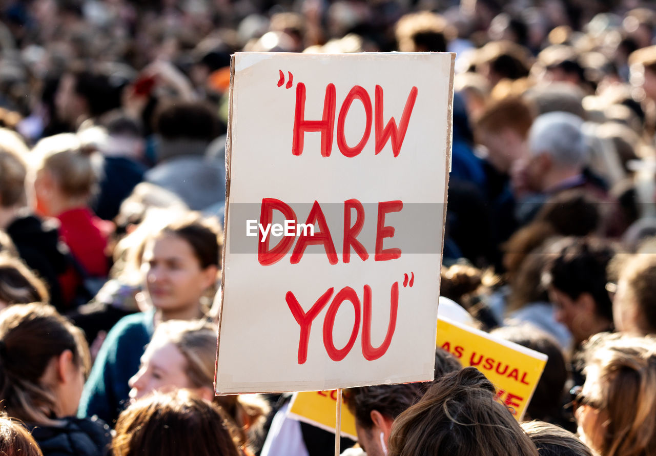 crowd, large group of people, protest, real people, text, women, communication, group of people, protestor, focus on foreground, holding, adult, message, men, banner - sign, emotion, social issues, event, anger, government, spectator