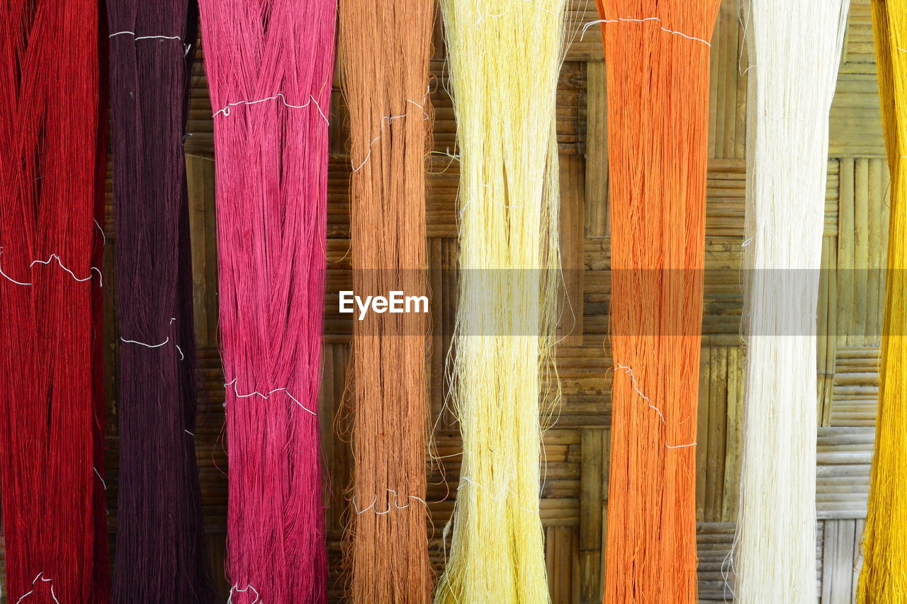 Close-up of colorful threads at factory