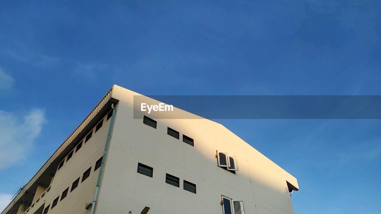 Low angle view of building against blue sky