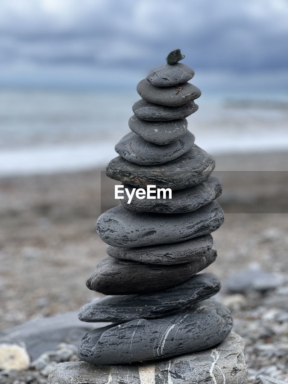 balance, beach, sand, land, zen-like, sea, pebble, rock, nature, water, shore, stone, no people, sky, focus on foreground, stability, tranquility, day, coast, beauty in nature, cloud, outdoors, tranquil scene, close-up, scenics - nature