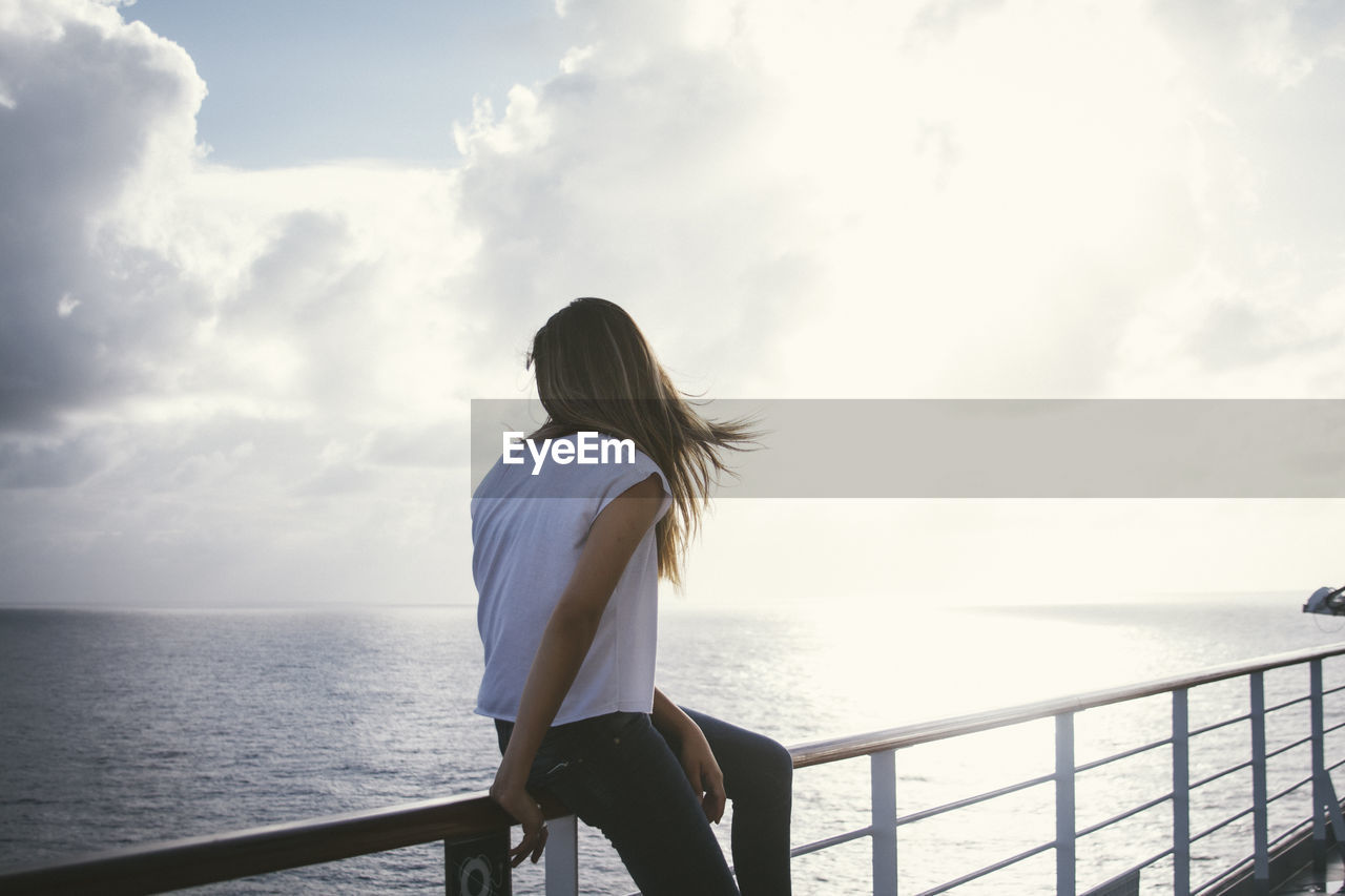 Rear view of woman looking at sea from observation point
