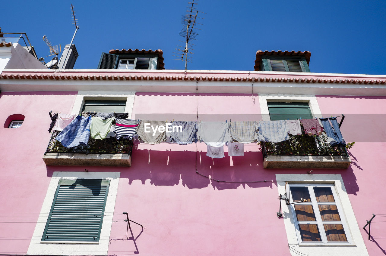 Low angle view of clothes drying at building 