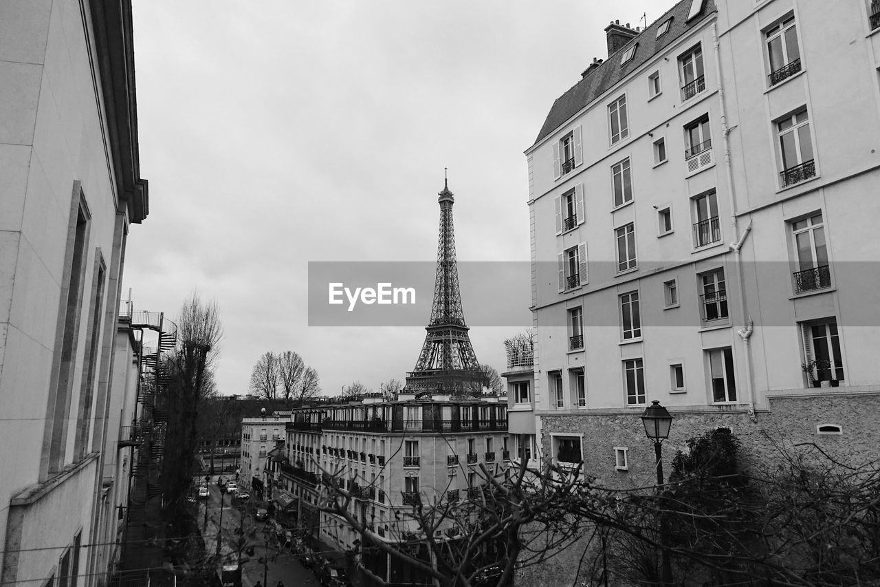 Low angle view of buildings against cloudy sky