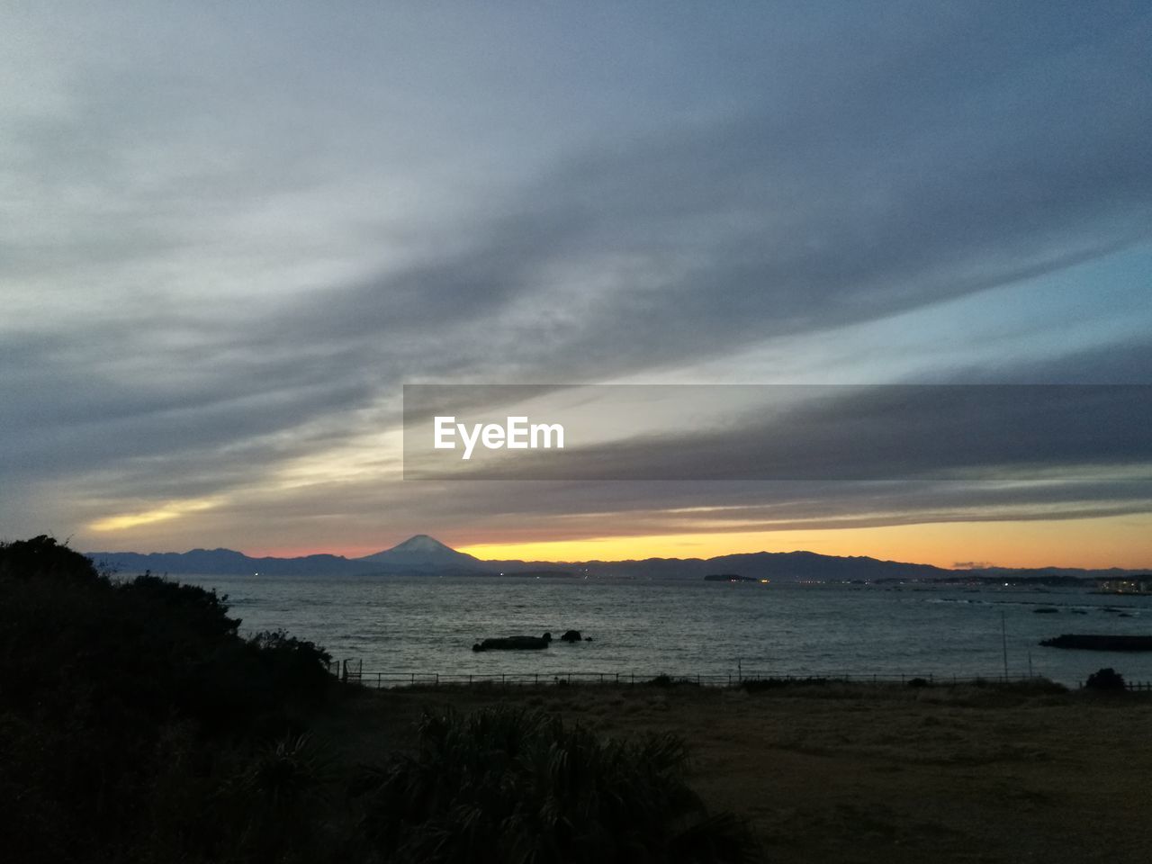 SCENIC VIEW OF BEACH DURING SUNSET