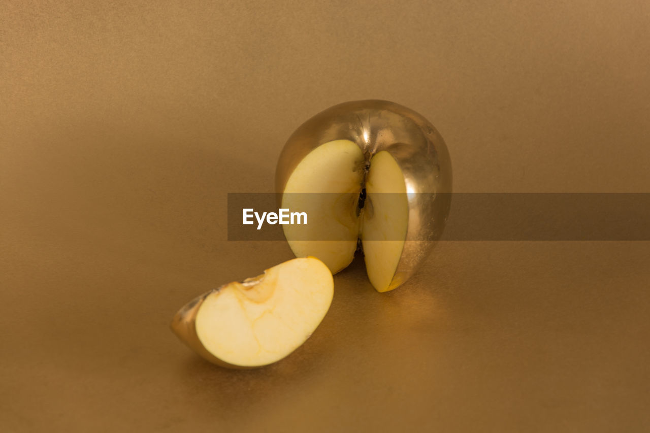 Golden apple in a cut on a golden background