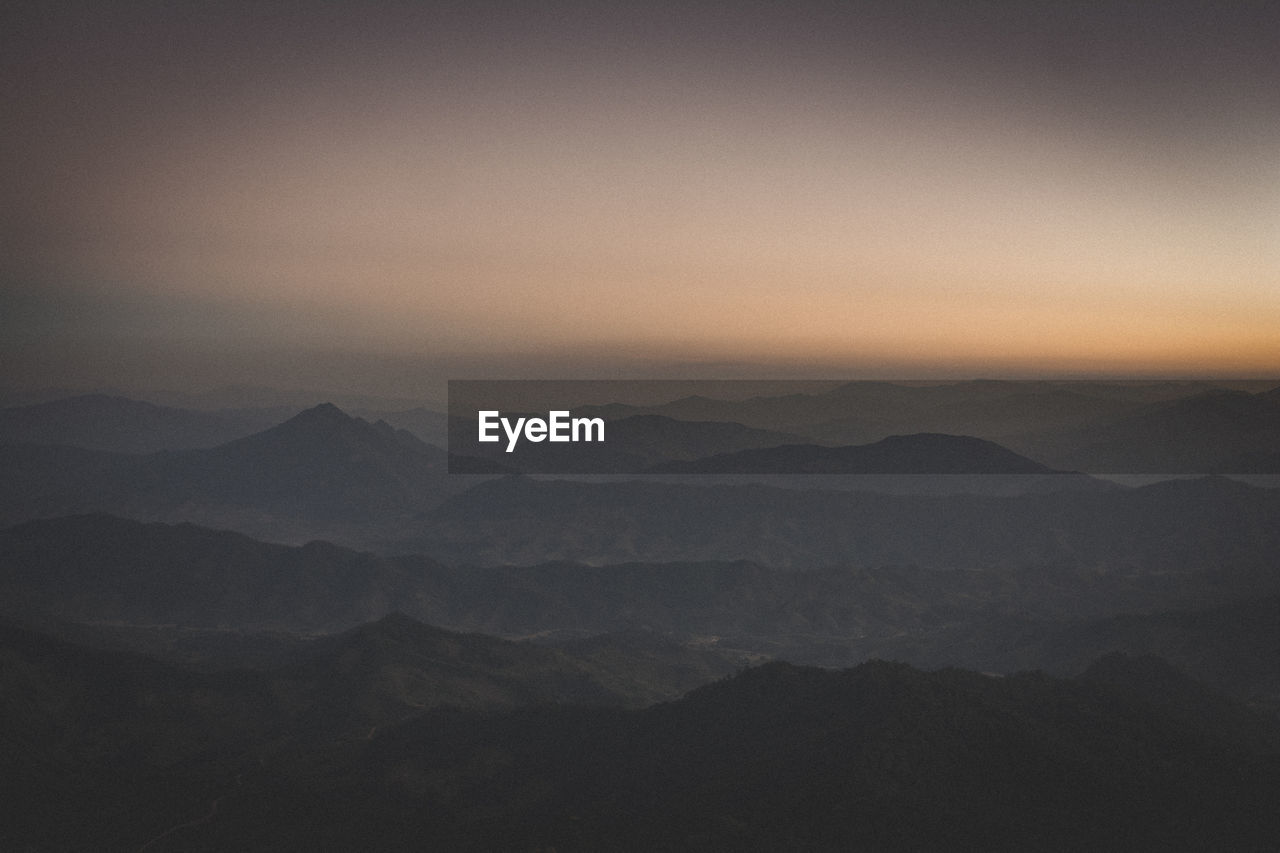 SCENIC VIEW OF MOUNTAIN AGAINST SKY DURING SUNSET