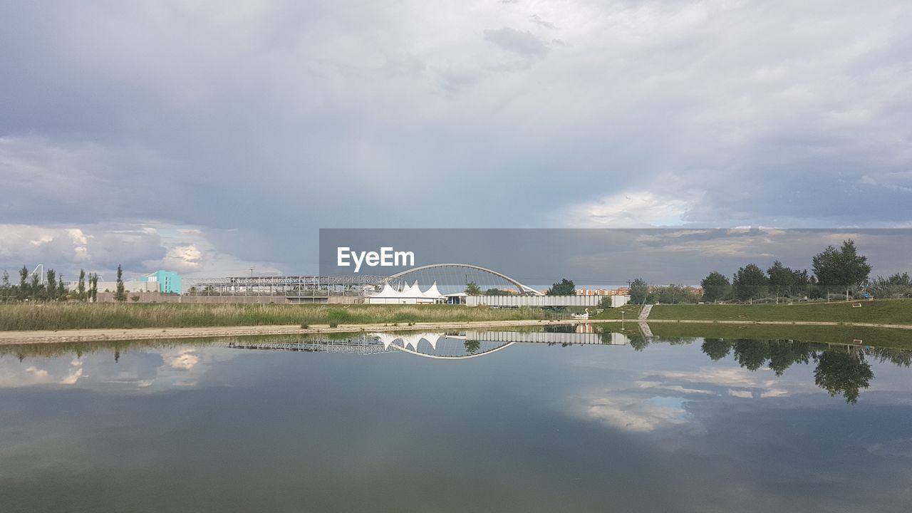 SCENIC VIEW OF LAKE BY BRIDGE AGAINST SKY