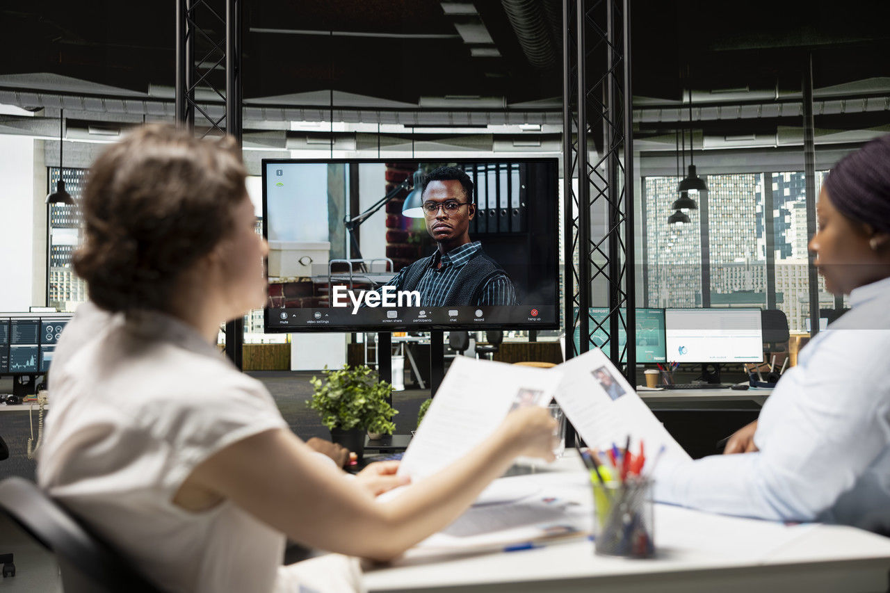 rear view of doctor examining patient in clinic
