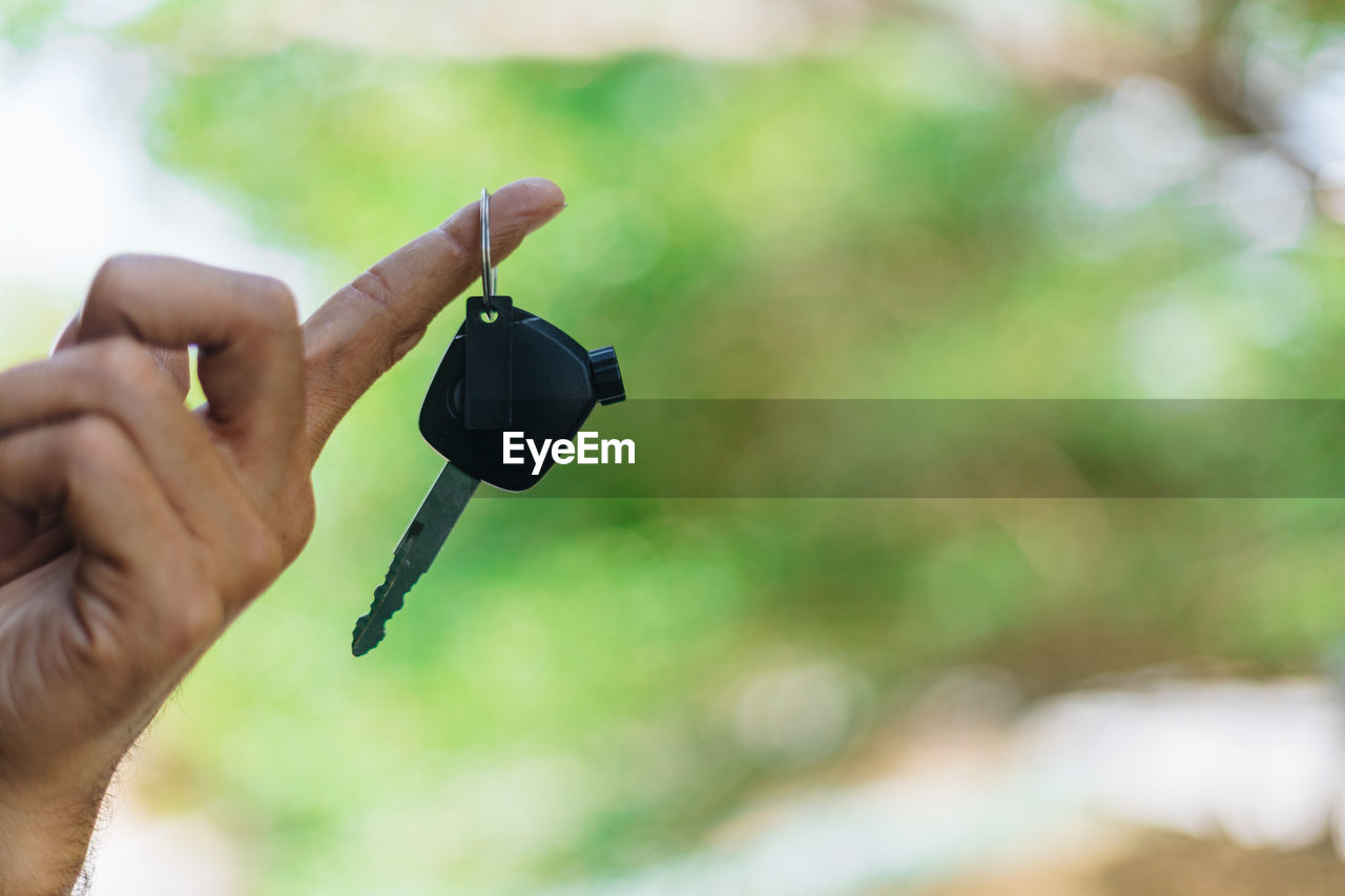 Close-up of person holding car key