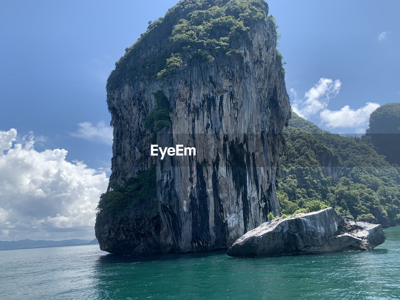 ROCK FORMATION IN SEA AGAINST SKY