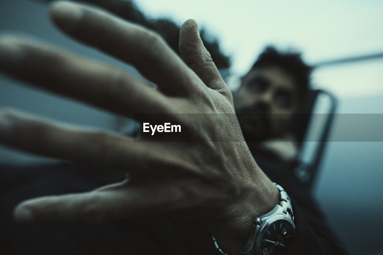 one person, hand, black, adult, close-up, blue, finger, indoors, lifestyles, men, focus on foreground, person, emotion