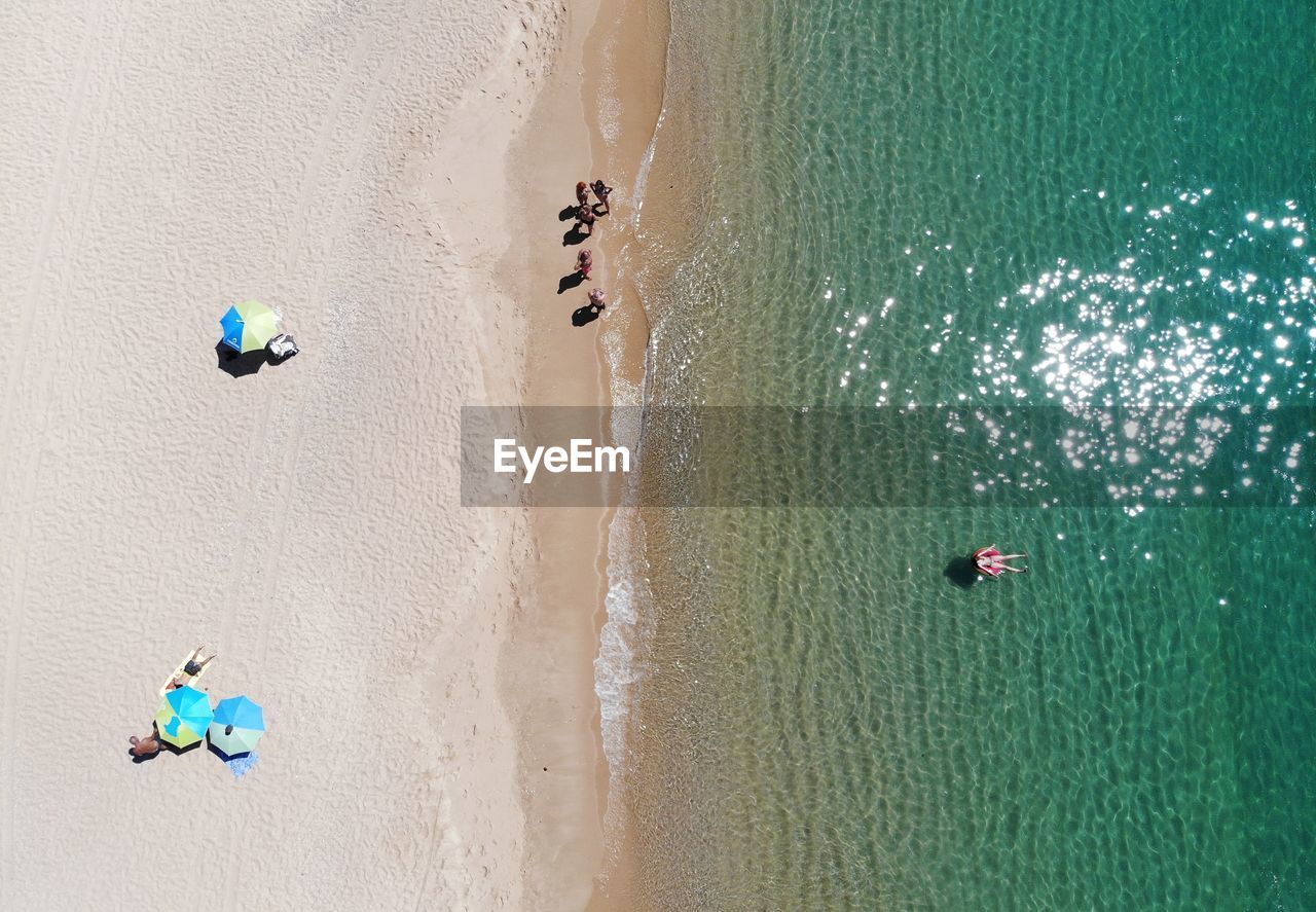 High angle view of people at beach on sunny day