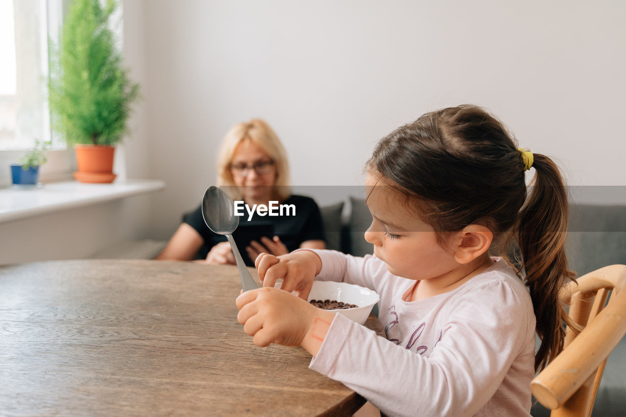 Portrait of mother and daughter at home