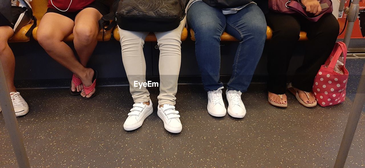 LOW SECTION OF PEOPLE STANDING ON BUS