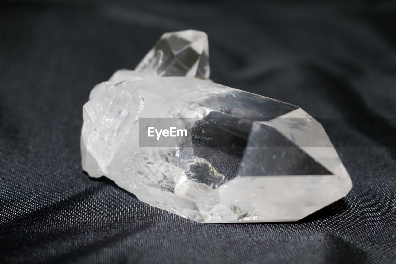 Close-up of quartz crystal stone on fabric