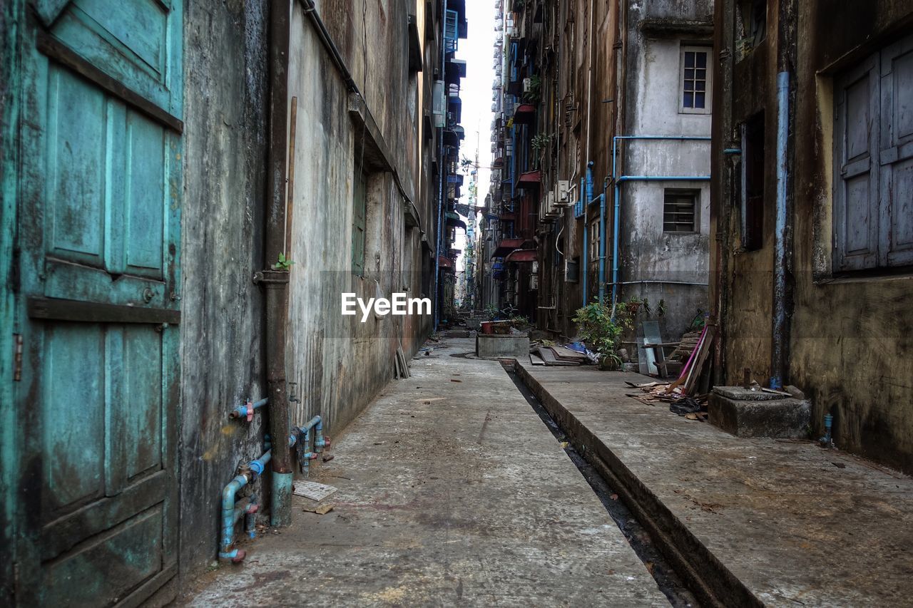 Dark, wet and dirty side street in chinatown, yangon, myanmar, burma