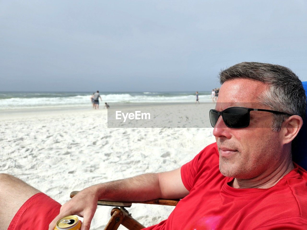 Portrait of man sitting at beach