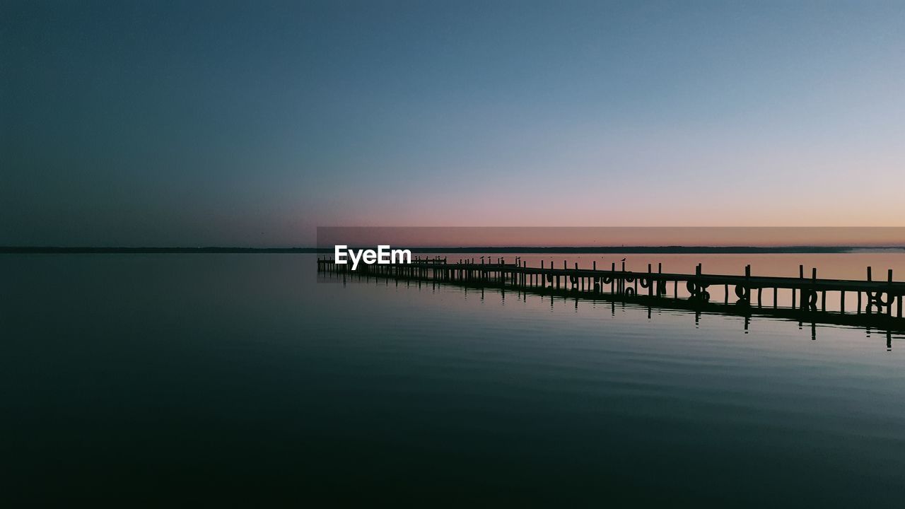 Scenic view of sea against clear sky during sunset