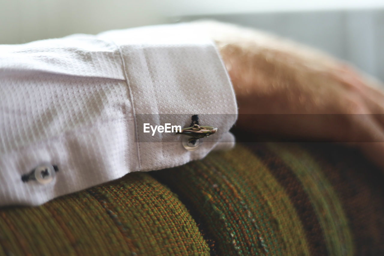 Close-up of cufflink on shirt