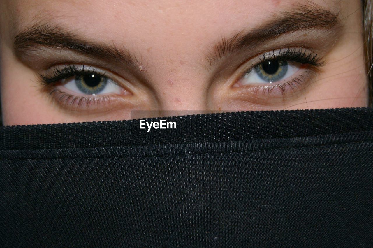 CLOSE-UP PORTRAIT OF HUMAN FACE COVERED WITH HAND