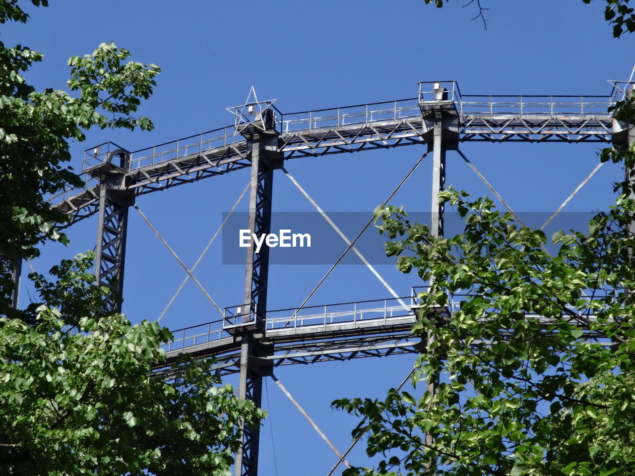 LOW ANGLE VIEW OF ELECTRICITY PYLON AGAINST CLEAR SKY