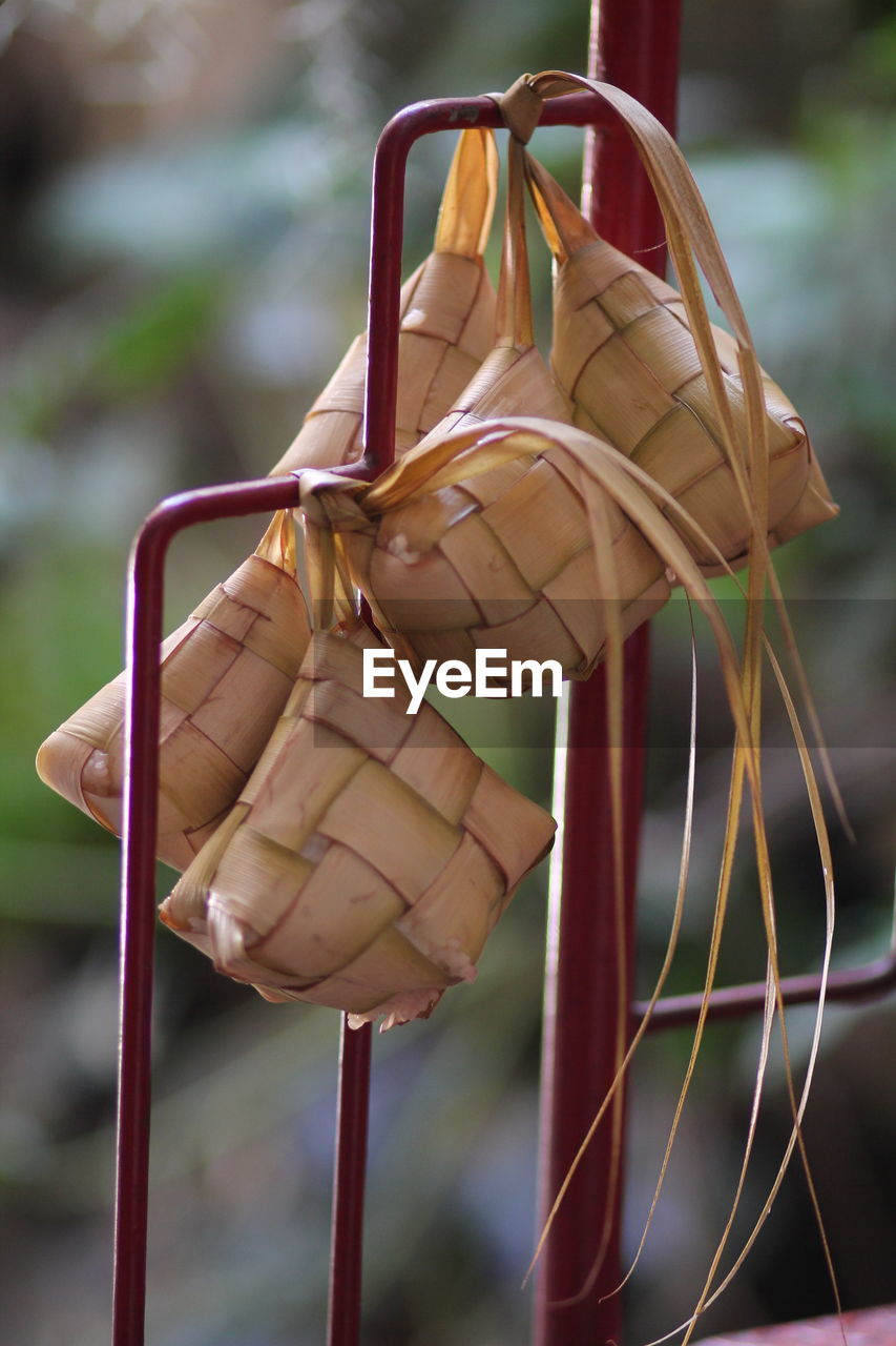 Close-up of food in wicker tied to metal