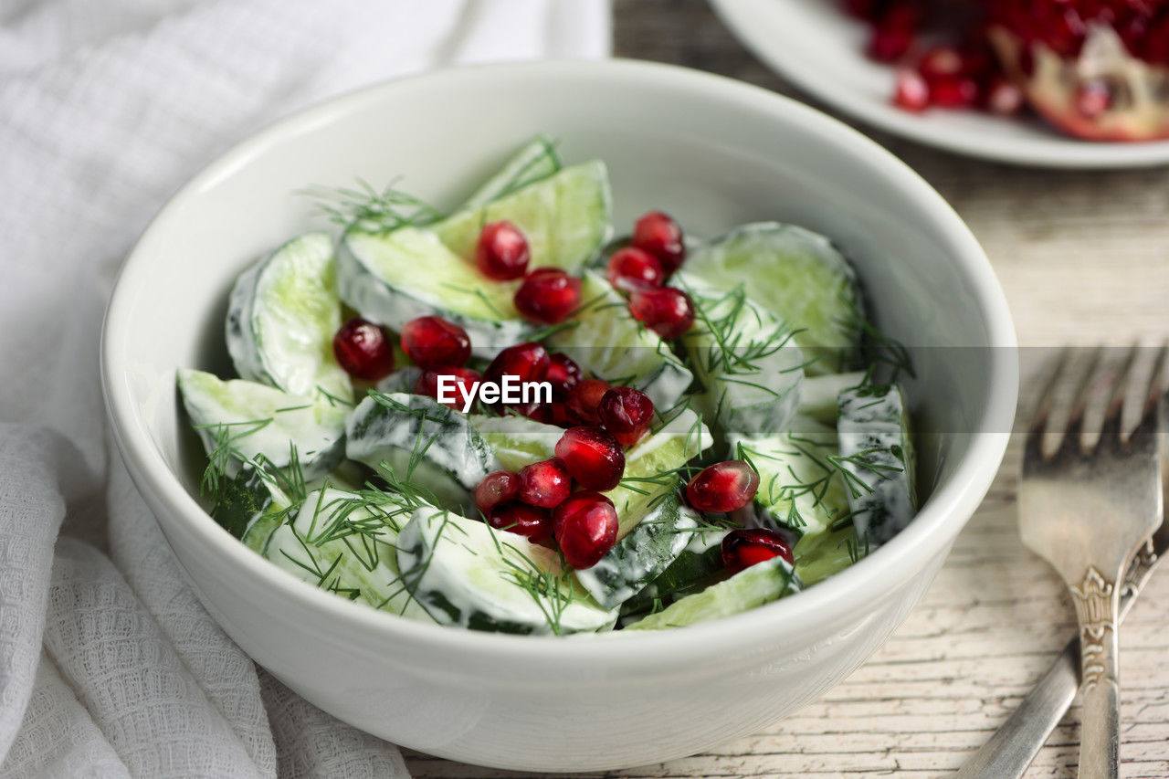 Fresh cucumber salad with dill and pomegranate kernels, in yoghurt sauce