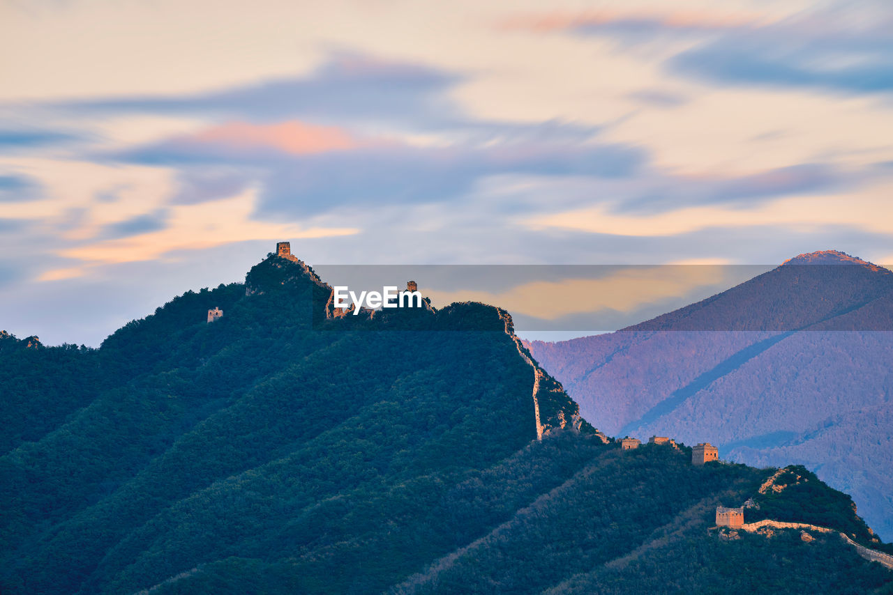 Scenic view of mountain against cloudy sky