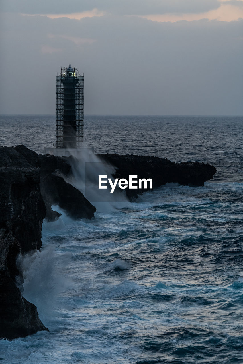 SCENIC VIEW OF ROCKS IN SEA AGAINST SKY