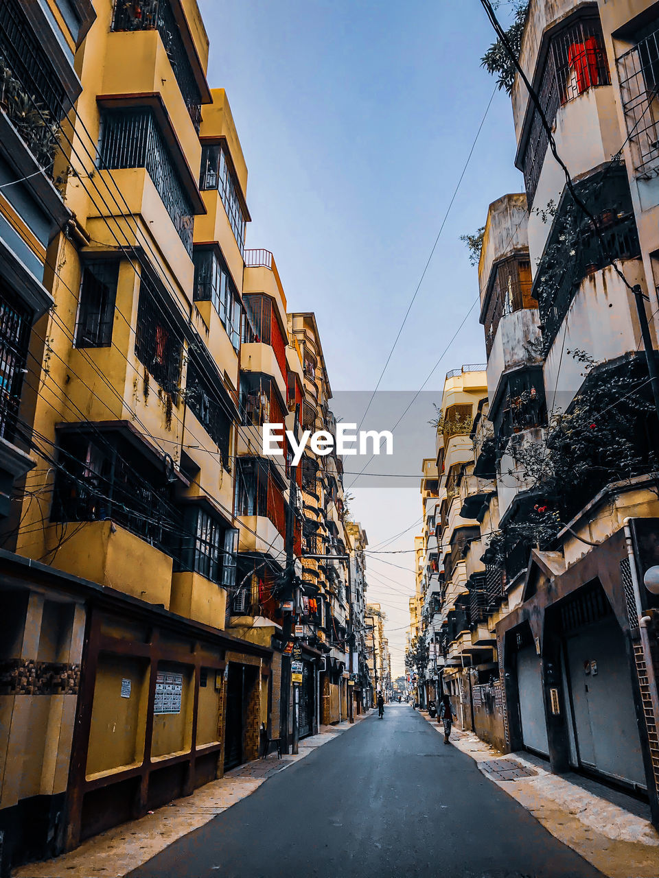 Street amidst buildings against sky in city