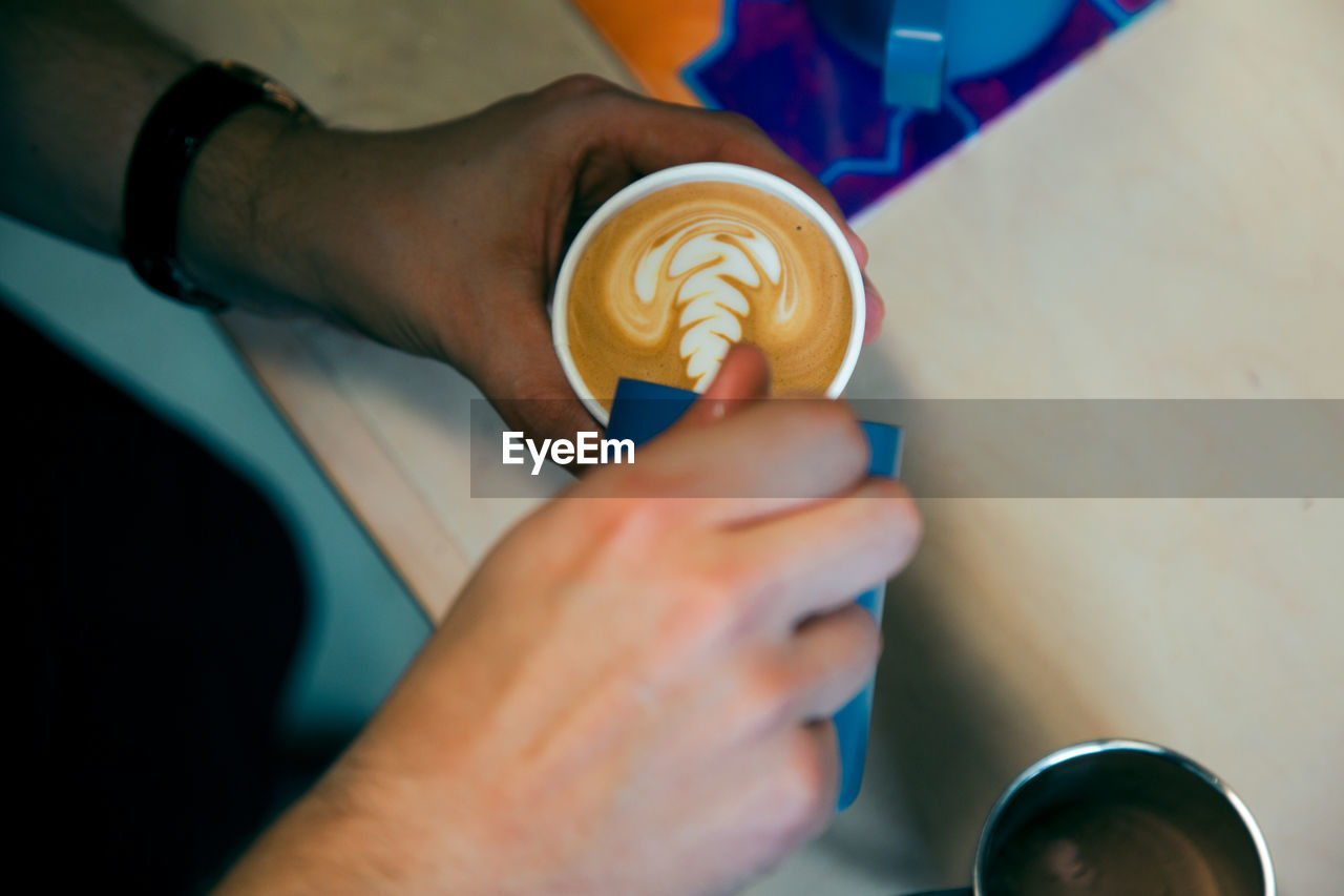 Close-up of man hand holding drink