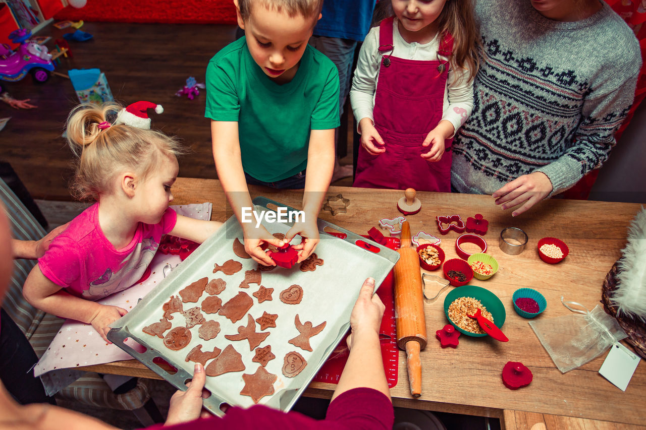 High angle view of children making cookies