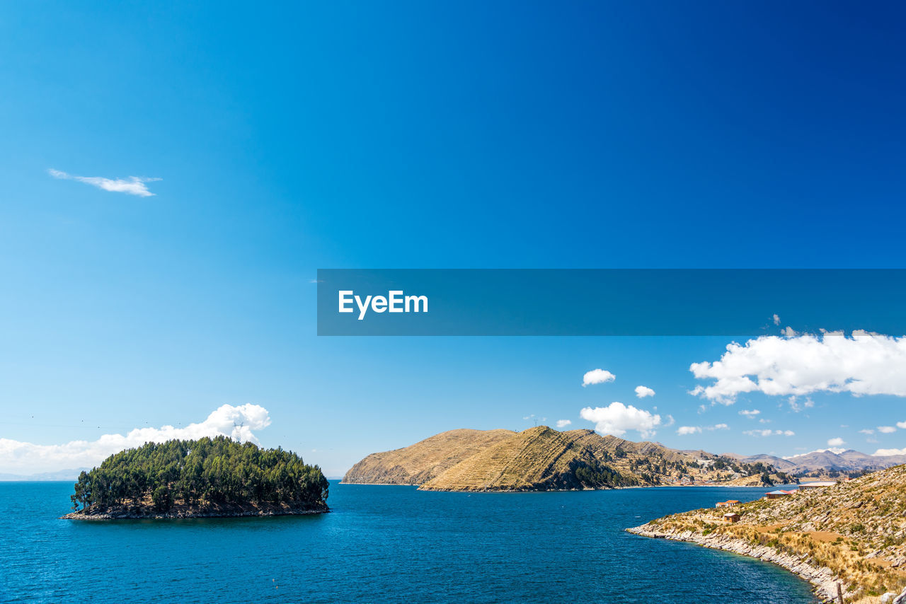 Panoramic view of landscape against blue sky