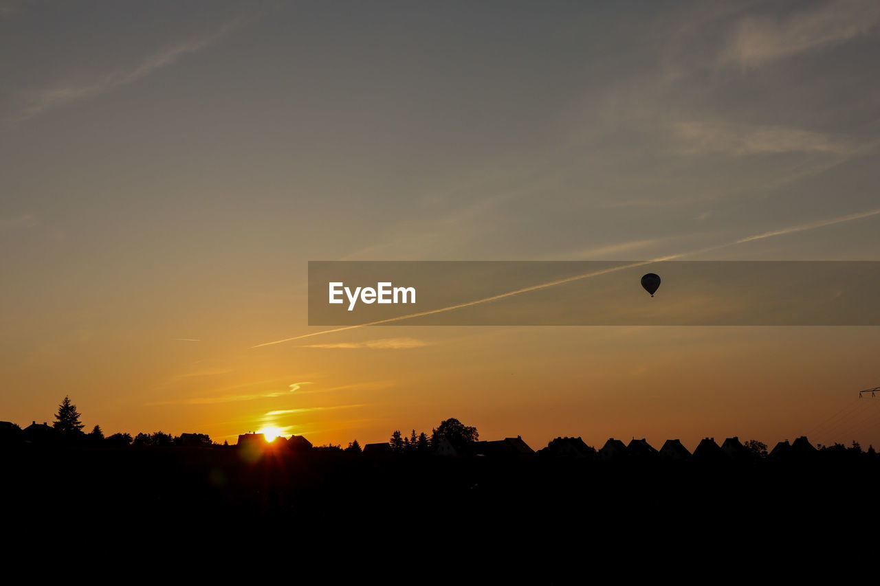 SILHOUETTE OF HOT AIR BALLOON AT SUNSET