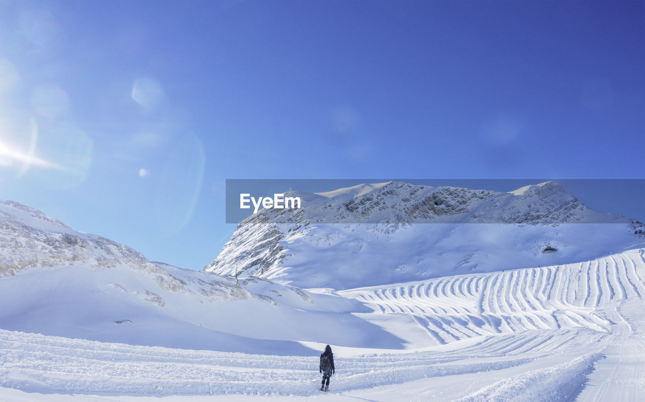 Full length of a person standing on snow covered landscape