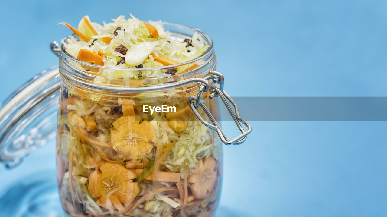 CLOSE-UP OF FRUIT IN GLASS JAR