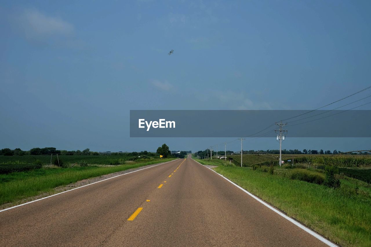 ROAD ON FIELD AGAINST SKY